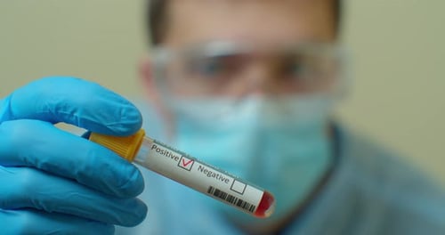 COVID-19 Positive Blood Test Held by Medical Professional