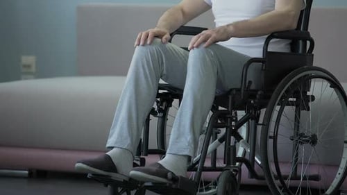 Man Sitting in Wheelchair Indoors