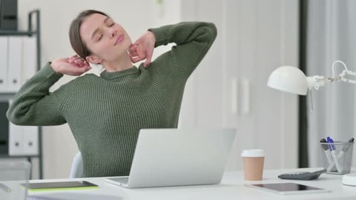 Young Woman Stretching at Work