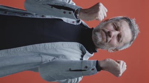 Determined Man Clenching Fists in Portrait Shot