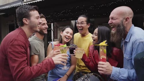 Friends Toasting Cocktails at an Urban Outdoor Bar