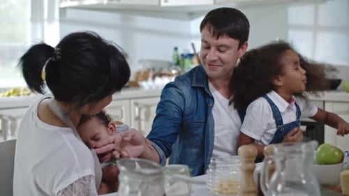 Diverse Family Sharing a Meal Together at Home