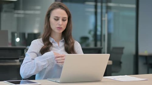 Young Adult Woman Working with Wrist Pain in Office