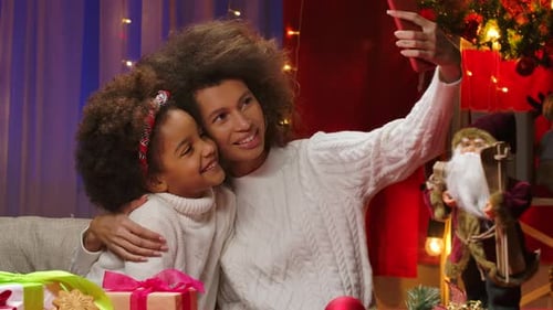 Woman and Child Taking Christmas Selfie Together