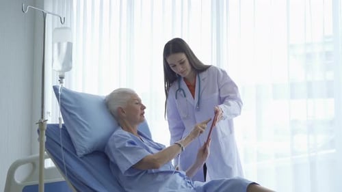 Doctor with Senior Patient in Hospital Room