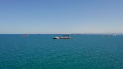 Heavy load carrier ship loaded with Electric Turbine Blades anchored at Sea, Aerial view.