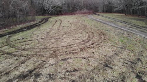 tire tracks in grass field destroyed aerial drone tracking