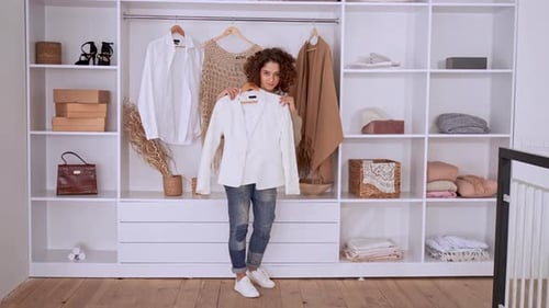 Young Woman Choosing Clothes from Wardrobe