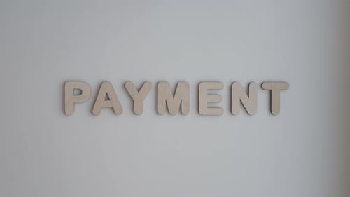 Wooden Letters Spelling Payment On White Surface