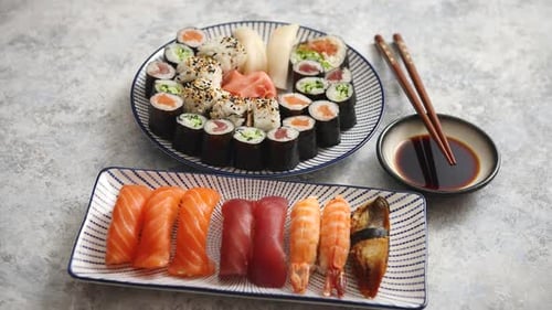 Asian Food Assortment. Various Sushi Rolls Placed on Ceramic Plates