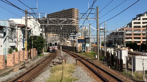 Train Approaching on Tracks on a Sunny Day