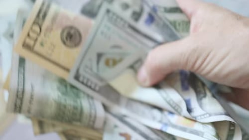 Hands Holding and Counting Dollar Bills Close Up