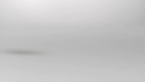 Egg Breaks Open After Falling on White Surface