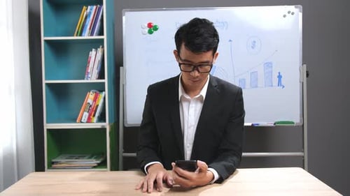 Asian Businessman Using Mobile Phone