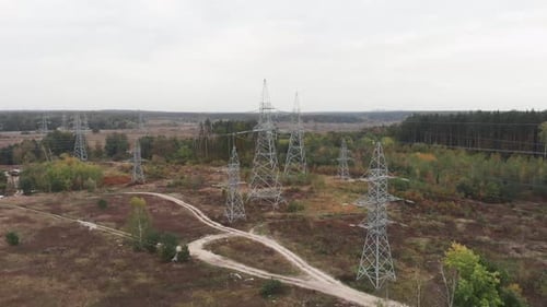 Transmission electricity steel pylon towers. High voltage electric towers in forest.