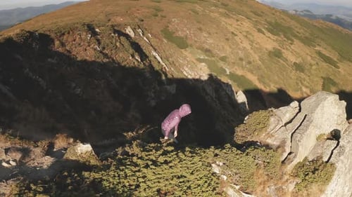 Closeup Aerial Girl Climb to Cliff Mountain Sun Top