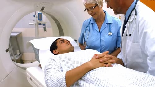 Medical Staff with Patient Next to CT Scanner