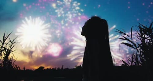 Girl Silhouette Watching Fireworks at Twilight