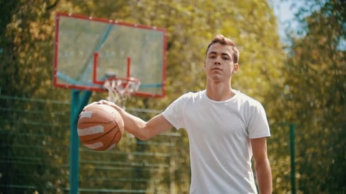 Young Adult Man With Basketball Outdoors