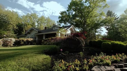 Wooden House in the Garden of Flowers in Summer Wide Shot
