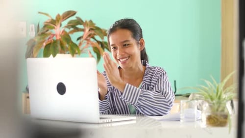 Cheerful Asian Student or Worker at Home Office with Laptop Smiles Happily.