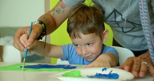 Child Painting with Parent Guidance at Home