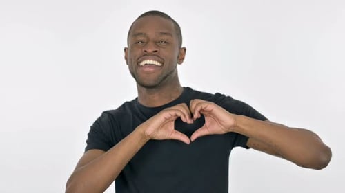 Smiling Man Makes Heart Shape with Hands