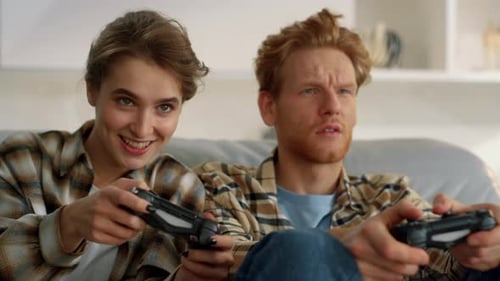 Couple Playing Video Games on the Couch Together