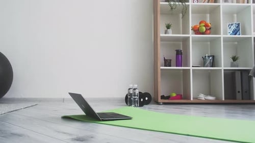 Home Workout Equipment on Mat with Laptop