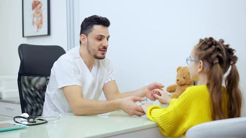 Friendly Doctor with Child in Medical Office