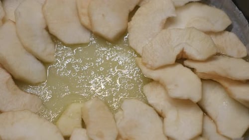 Close-up of apple pie detailed preparation 4K 2160p 30fps UltraHD footage - Fruit pieces in baking