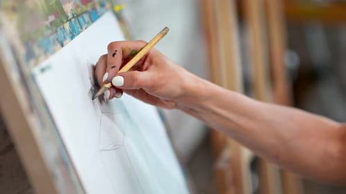 Hand Drawing on Easel in Art Studio