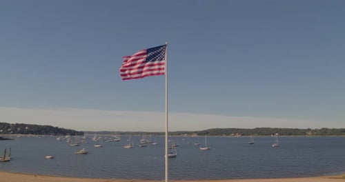 Scenic View of Bay with American Flag and Sailboats