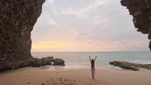 Woman on Tropical Beach with Arms Raised