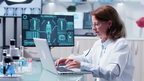 Woman Scientist Working on Laptop in Modern Laboratory