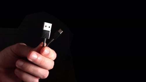 Hand Holds USB A and USB C Cable