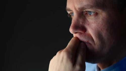 Man Ponders Intently in Profile Close Up