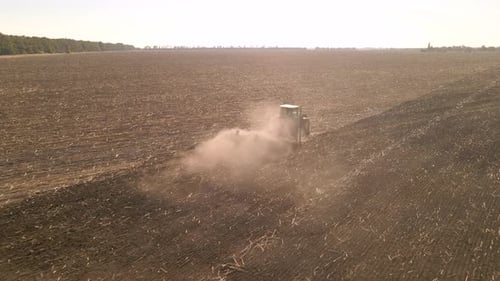Slow Motion Drone View of Tractor Plowing Farm Field