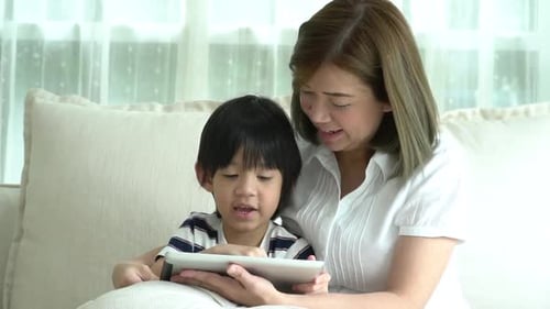 Woman and Child use Tablet at Home