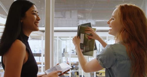 Smiling Women Discuss Business in Modern Office