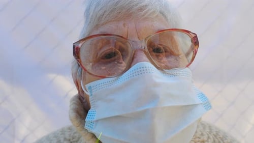Portrait of Granny Wearing Protective Mask From Virus. Elderly Lady Looking Into Camera Showing Sad