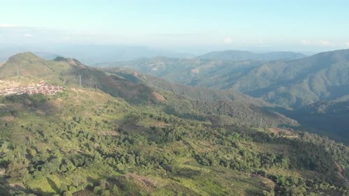 Unique aerial view of tea plantation on hill and tea pickers village on ridge
