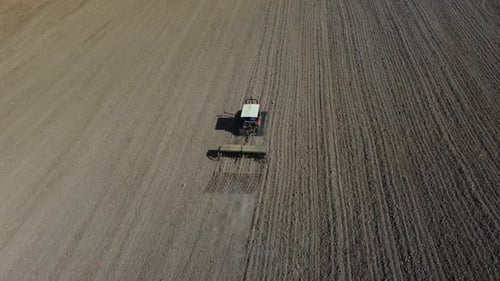 Tractor Working in Agriculture Rural Field, Plowing Soil for Wheat
