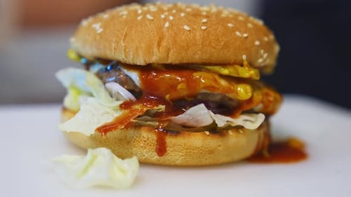 Hands Assemble Delicious Burger Close-Up