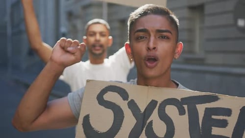 Young Adults Protest In Urban Environment Holding Signs