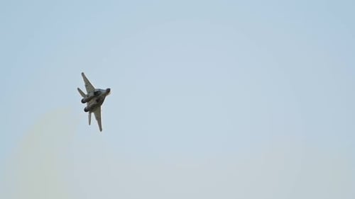 A Green Military Reactive Plane Flying in the Sky and Performing a Show