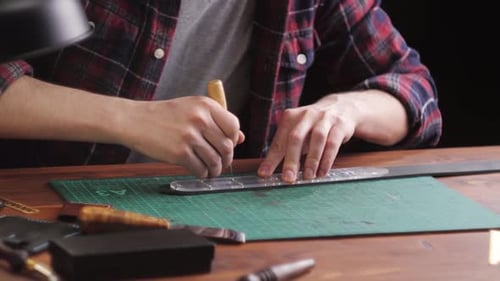 Craftsman Working Leather at Workbench