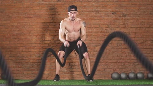 Determined Male Athlete Performing Waves By Battle Rope, in Crossfit Club, Slow Motion