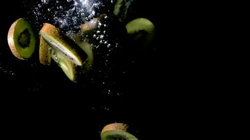 Kiwi Slices Falling Into Water in Slow Motion