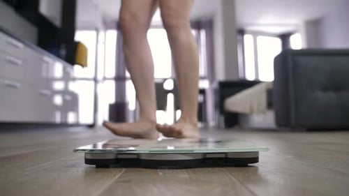Woman Steps on Scale in Modern Home